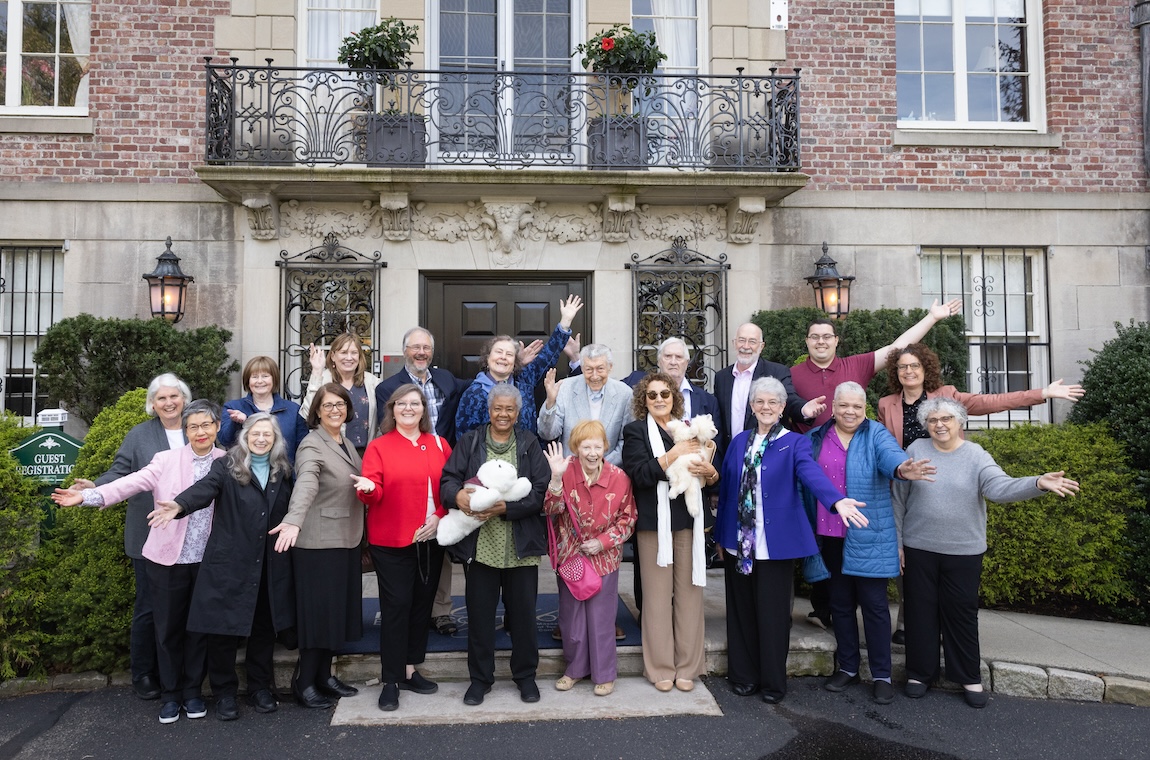 Event attendees gather for a group photo in front of Endicott House