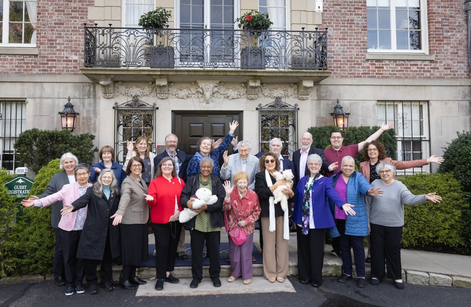 Event attendees gather for a group photo in front of Endicott House